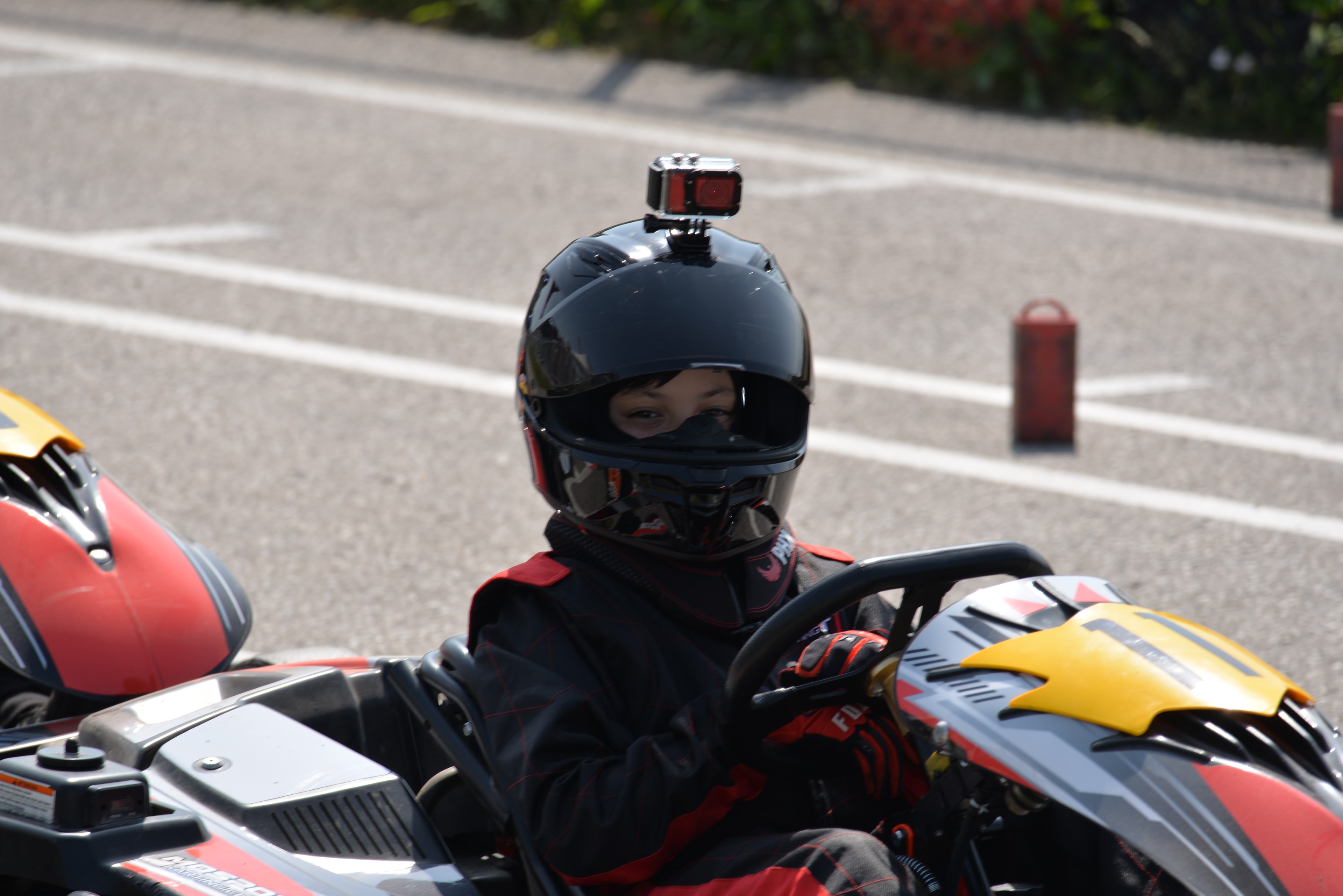 Carter thumbs up in front of kart
